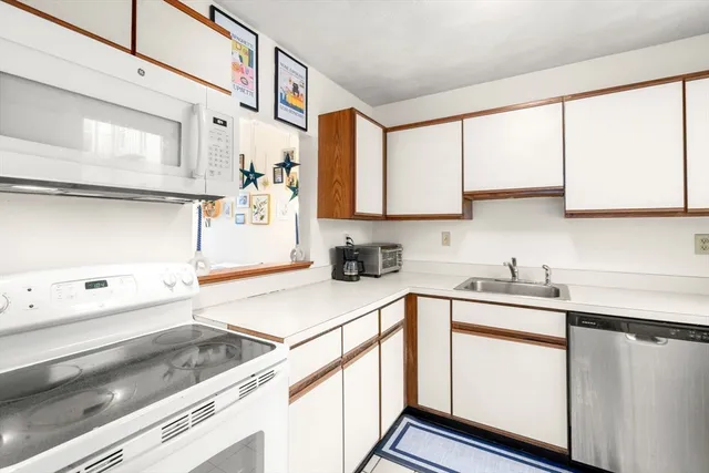 a kitchen with a sink cabinets and window
