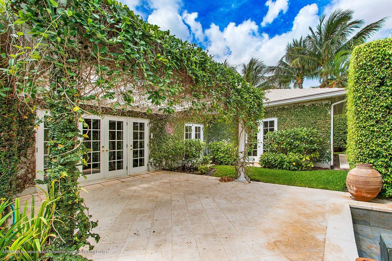 255 Ridgeview Drive Palm Beach, FL 33480 - Photo 13 of 20 a view of a house with a small yard and plants