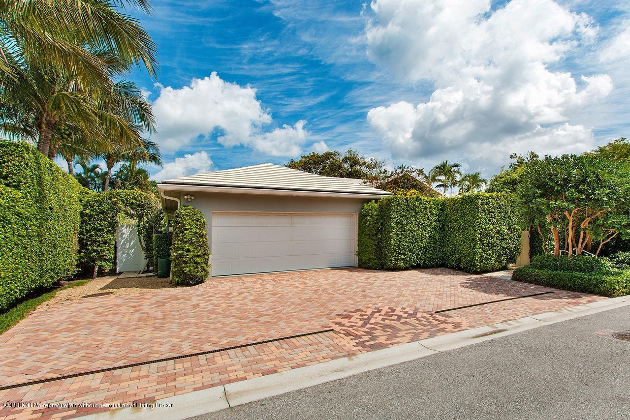 255 Ridgeview Drive Palm Beach, FL 33480 - Photo 18 of 20 a view of a house with a yard and garage