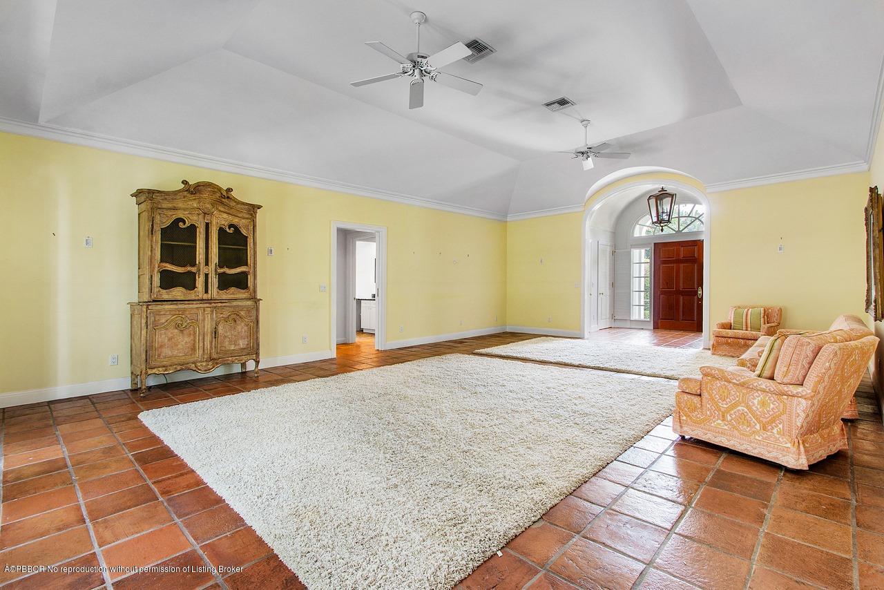 255 Ridgeview Drive Palm Beach, FL 33480 - Photo 4 of 20 a living room with a couch and chandelier