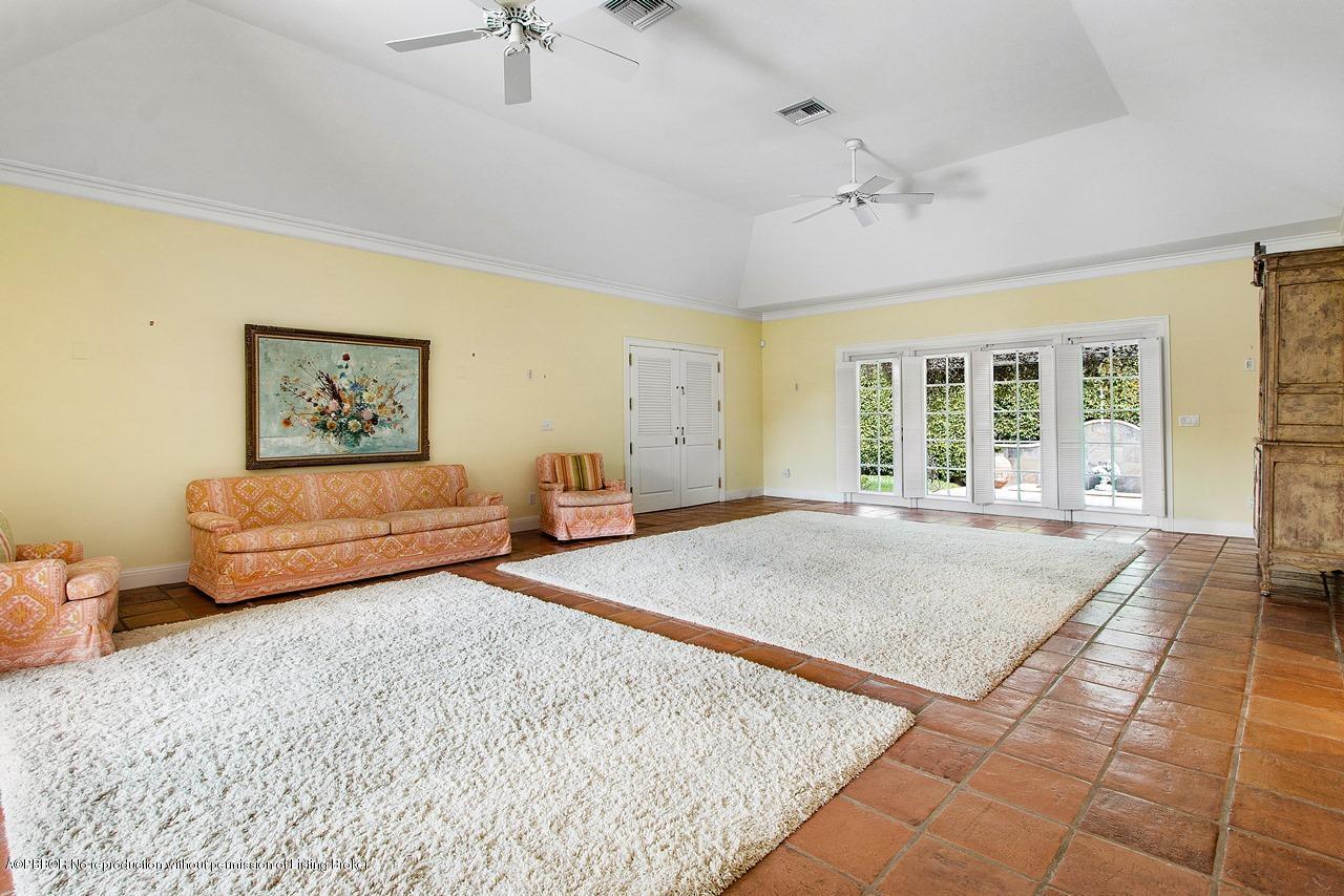 255 Ridgeview Drive Palm Beach, FL 33480 - Photo 5 of 20 a spacious bedroom with a large bed a rug and wooden floor