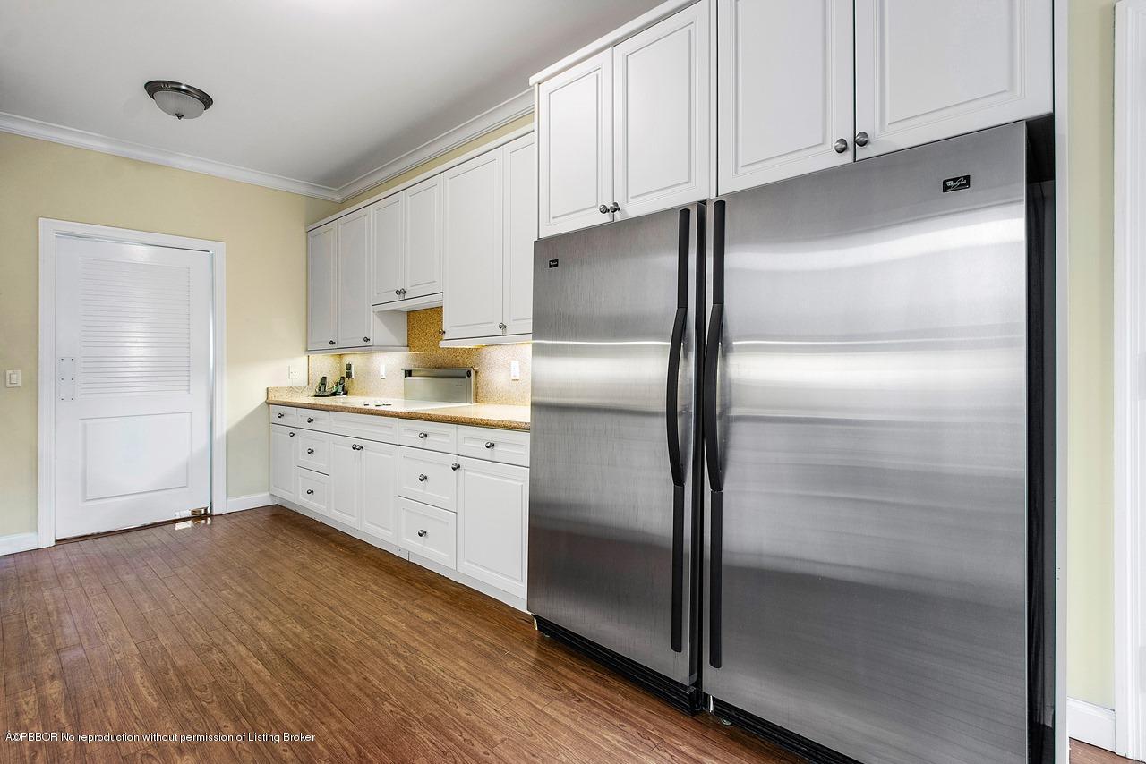 255 Ridgeview Drive Palm Beach, FL 33480 - Photo 6 of 20 a kitchen with white cabinets and stainless steel appliances