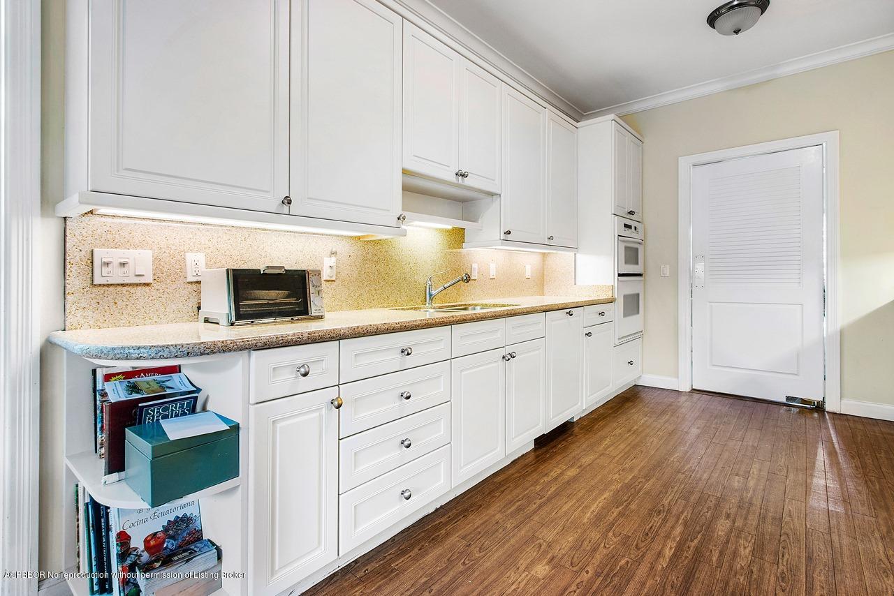 255 Ridgeview Drive Palm Beach, FL 33480 - Photo 7 of 20 a kitchen with cabinets and wooden floor