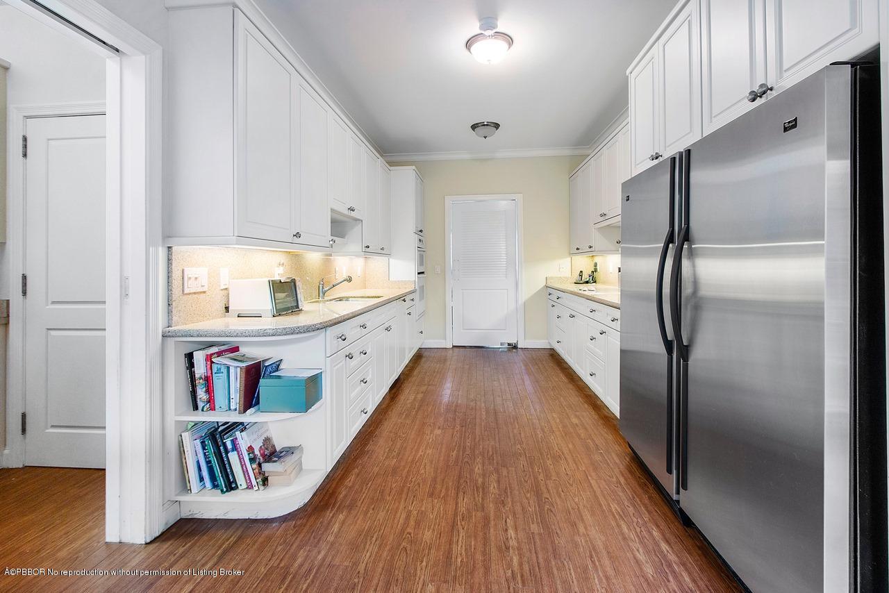 255 Ridgeview Drive Palm Beach, FL 33480 - Photo 8 of 20 a kitchen with kitchen island a refrigerator and a sink