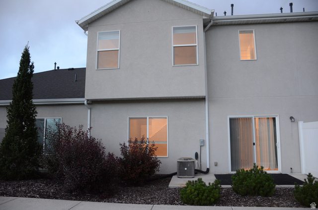 1842 South 1280th Street West Logan, UT 84321 - Photo 3 of 21 Rear exterior featuring stucco siding, multiple windows, and a sliding glass door