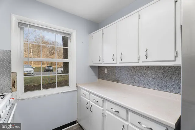 a view white cabinets and a wooden floor