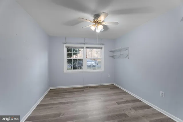 a view of an empty room with a ceiling fan