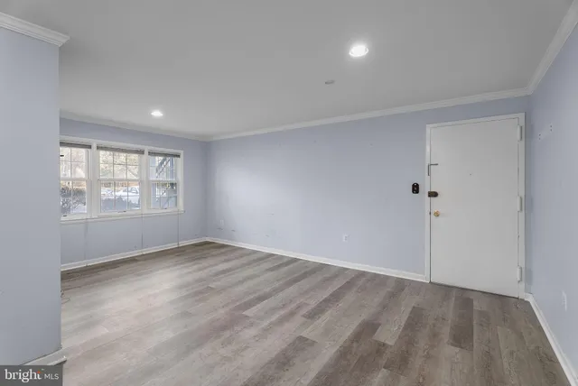 an empty room with windows and closet