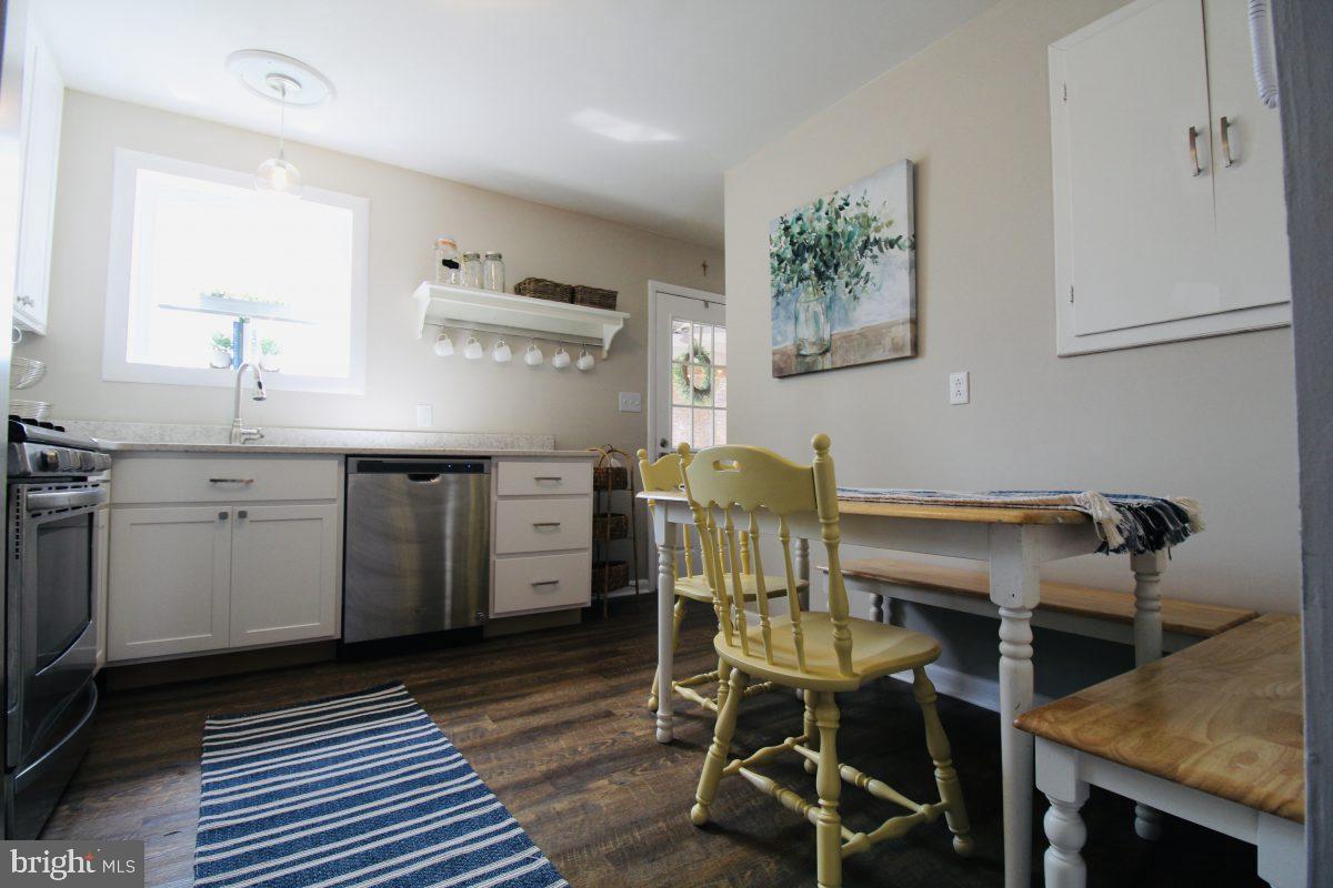 388 Nimitz Road Dover, DE 19901 - Photo 3 of 25 a kitchen with a table chairs and microwave