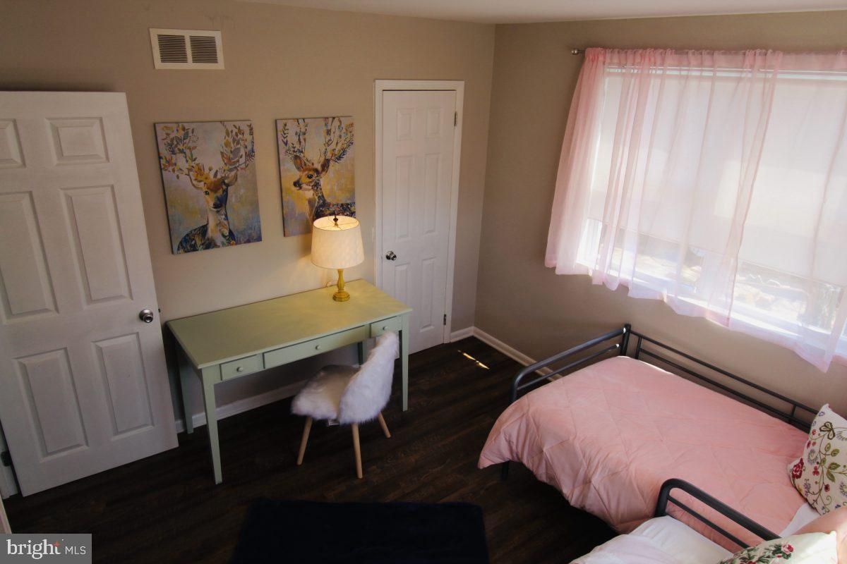 388 Nimitz Road Dover, DE 19901 - Photo 25 of 25 a bedroom with a bed and a table in it