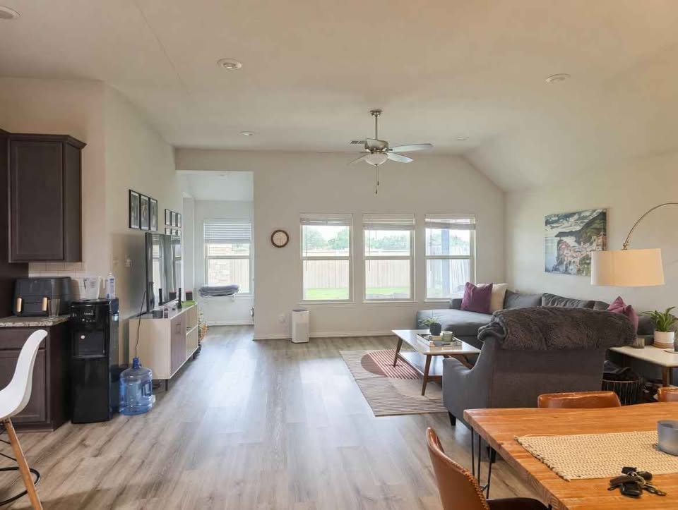4105 Gildas Path Pflugerville, TX 78660 - Photo 3 of 15 Natural light floods this inviting living space, connecting a casual dining area to an open-concept family room.