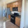 a kitchen with stainless steel appliances granite countertop a stove and a refrigerator