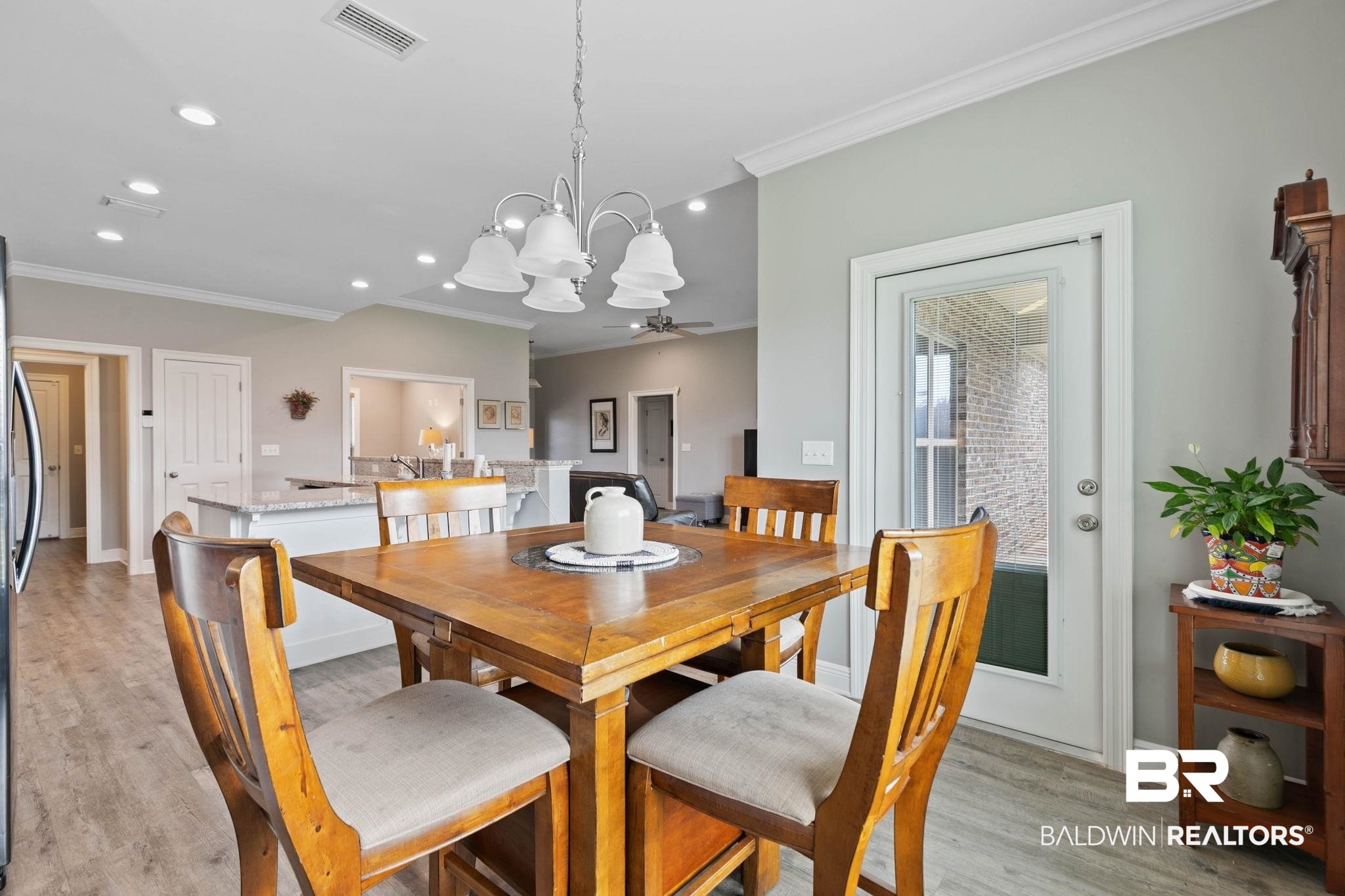 9388 Pembrook Loop Fairhope, AL 36532 - Photo 28 of 53 Dining room featuring crown molding, light wood-style flooring, recessed lighting, and a chandelier