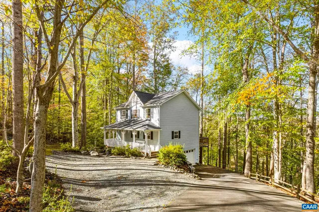 a white toilet sitting next to a white wall