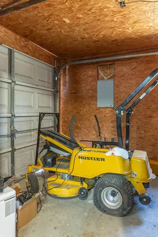 a view of a house with large trees and playing area
