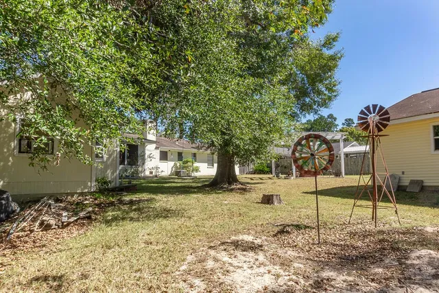 a view of a house with yard and sitting area