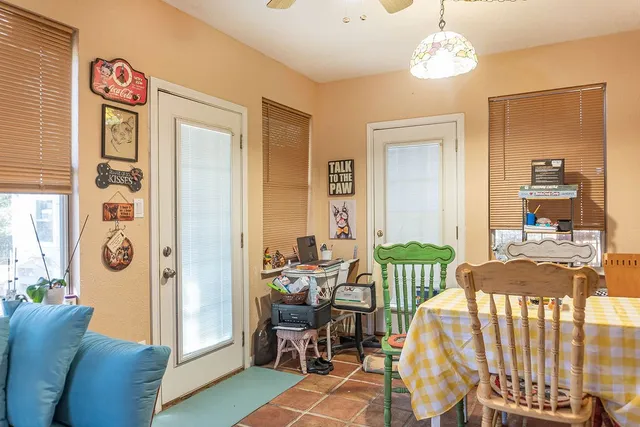 a view of a dining room with furniture and chandelier
