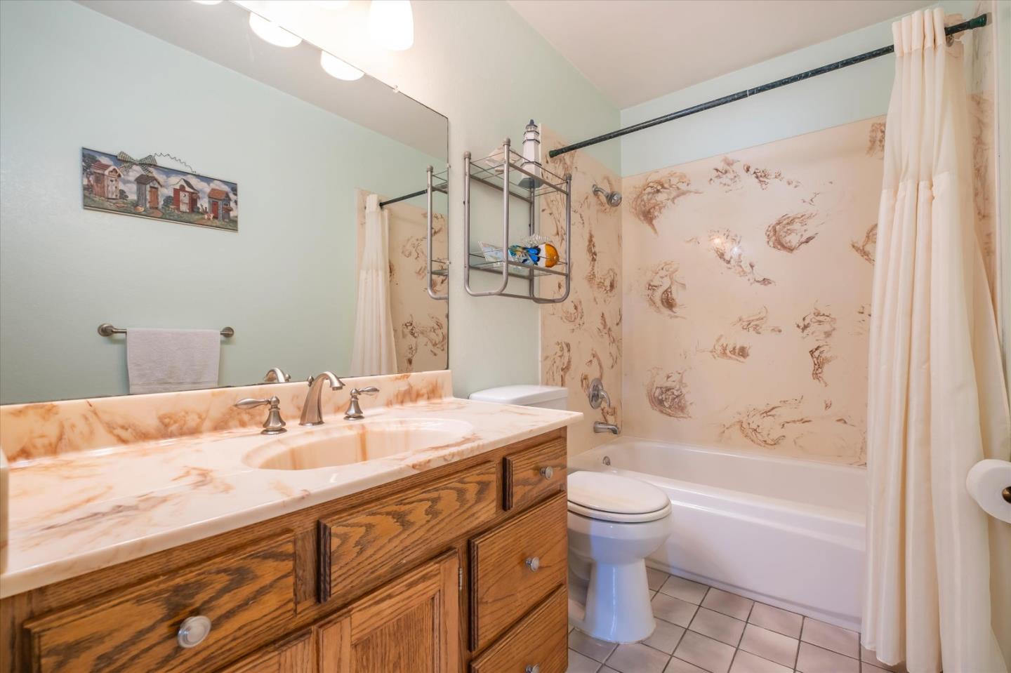 6195 Rockrose Drive Newark, CA 94560 - Photo 20 of 24 a bathroom with a granite countertop sink a toilet and shower