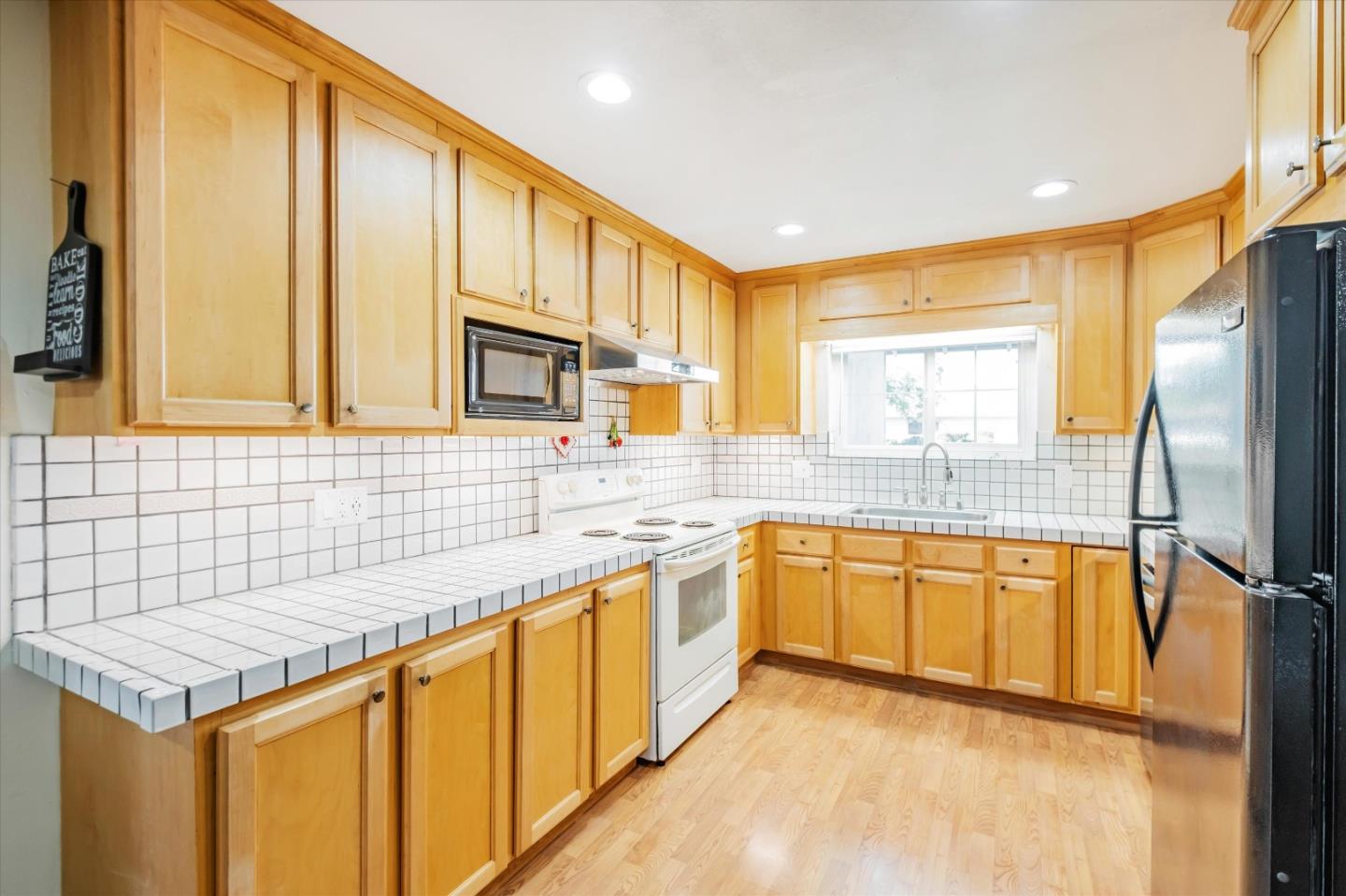 6195 Rockrose Drive Newark, CA 94560 - Photo 4 of 24 a kitchen with stainless steel appliances granite countertop a sink and cabinets