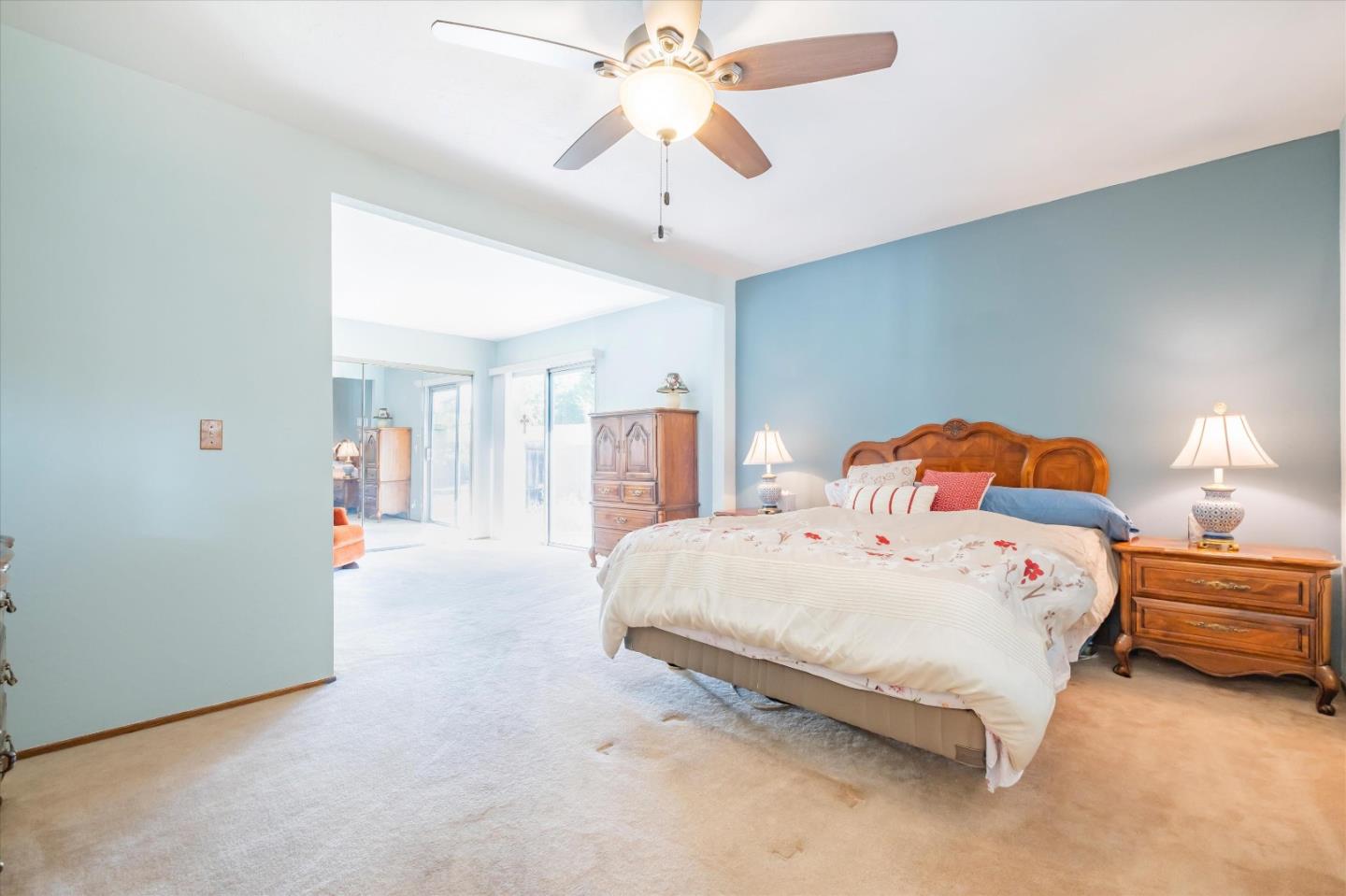 6195 Rockrose Drive Newark, CA 94560 - Photo 8 of 24 a bedroom with a bed and a chandelier