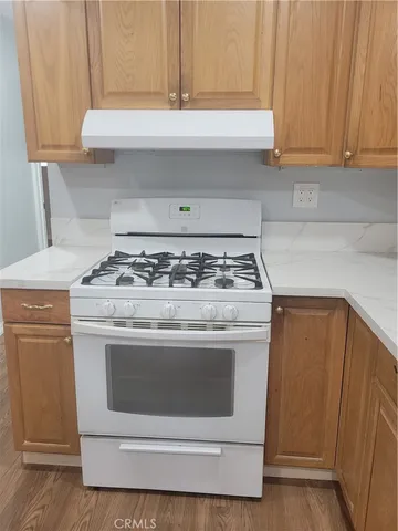 a stove top oven sitting inside of a kitchen