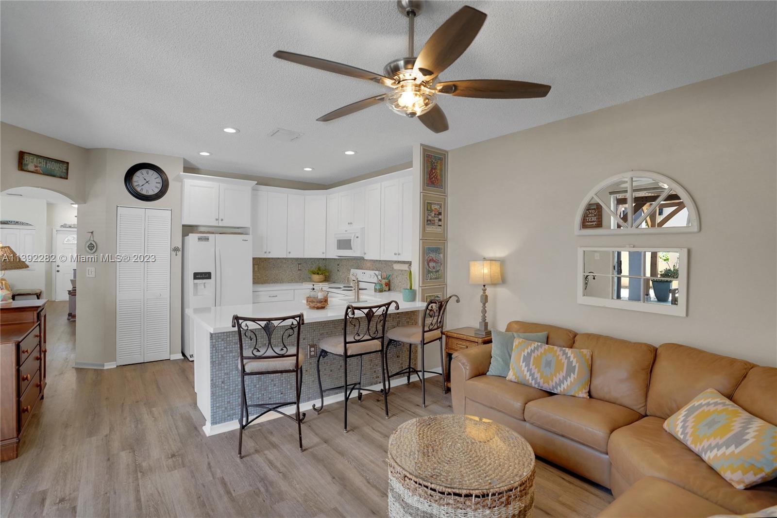 3850 Tree Top Road Cooper City, FL 33026 - Photo 13 of 34 a living room with furniture kitchen view and a chandelier