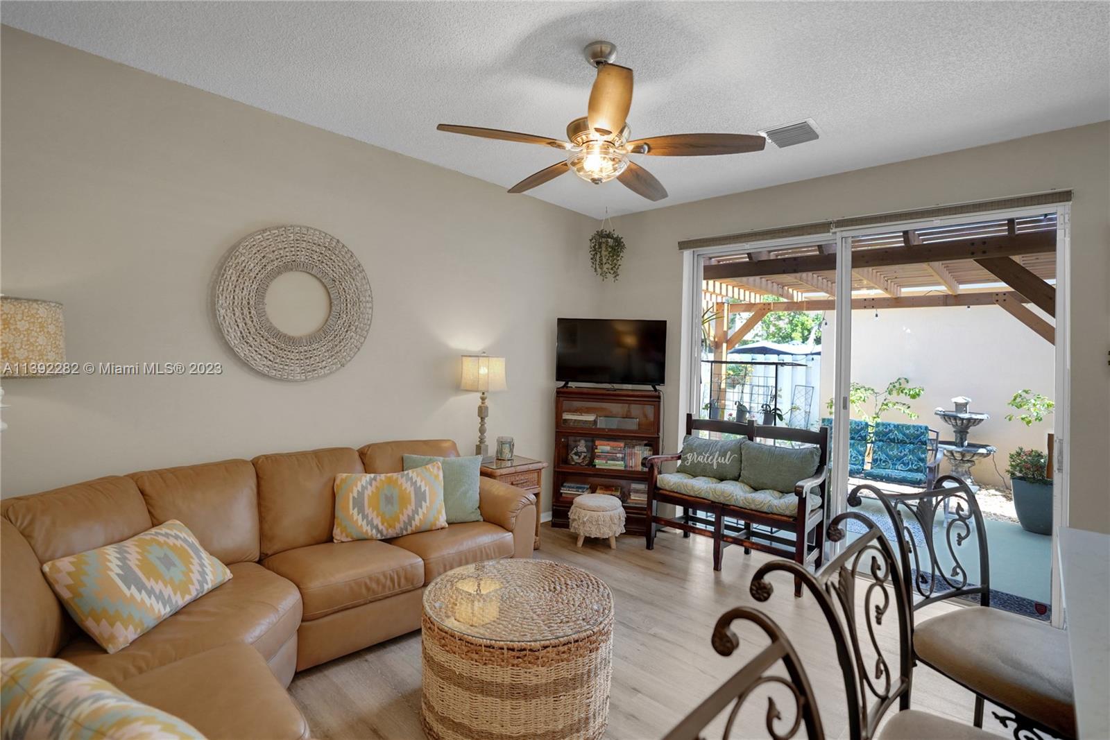 3850 Tree Top Road Cooper City, FL 33026 - Photo 15 of 34 a living room with furniture a flat screen tv and a large window