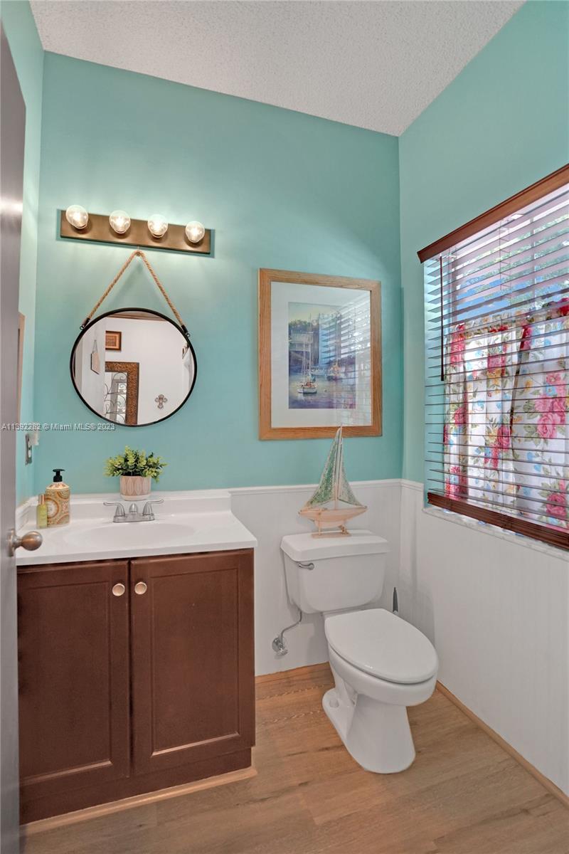 3850 Tree Top Road Cooper City, FL 33026 - Photo 16 of 34 a bathroom with a toilet a sink and mirror