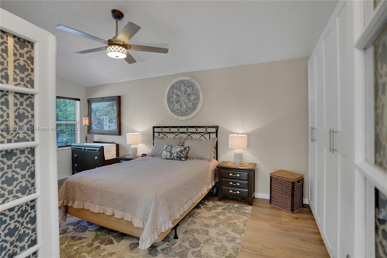 3850 Tree Top Road Cooper City, FL 33026 - Photo 18 of 34 a bedroom with a bed and a chandelier