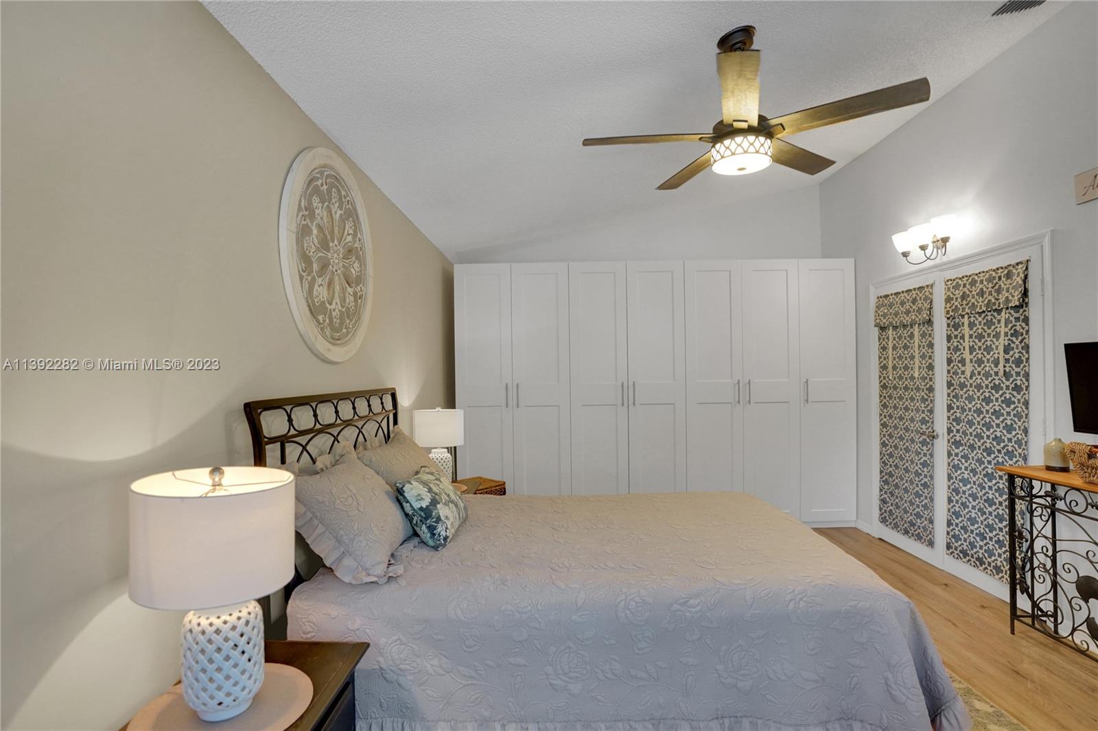 3850 Tree Top Road Cooper City, FL 33026 - Photo 21 of 34 a spacious bedroom with a bed and chandelier