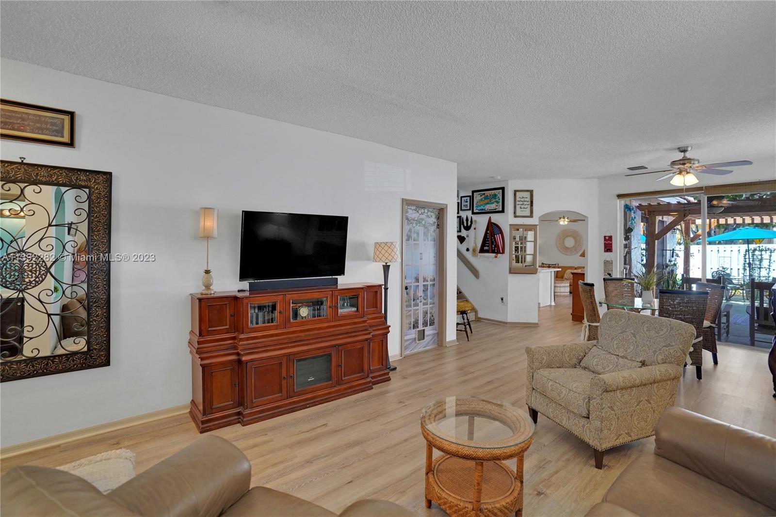 3850 Tree Top Road Cooper City, FL 33026 - Photo 3 of 34 a living room with furniture and a flat screen tv