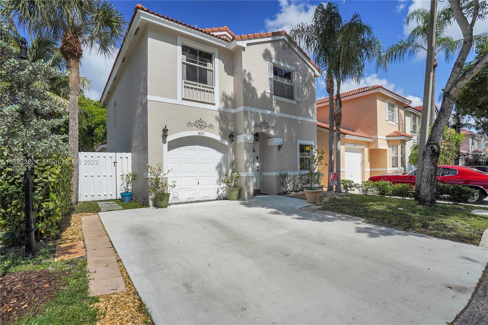 3850 Tree Top Road Cooper City, FL 33026 - Photo 34 of 34 a front view of a house with a garden and trees