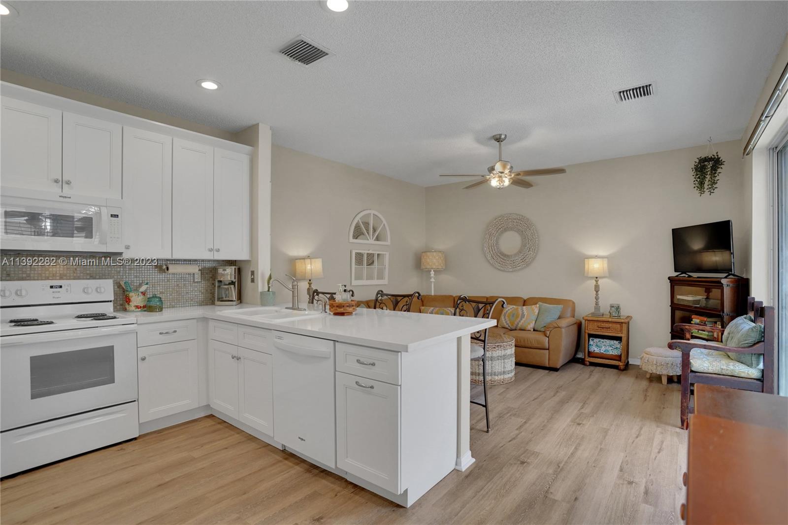 3850 Tree Top Road Cooper City, FL 33026 - Photo 9 of 34 a open kitchen with cabinets a stove and a wooden floor