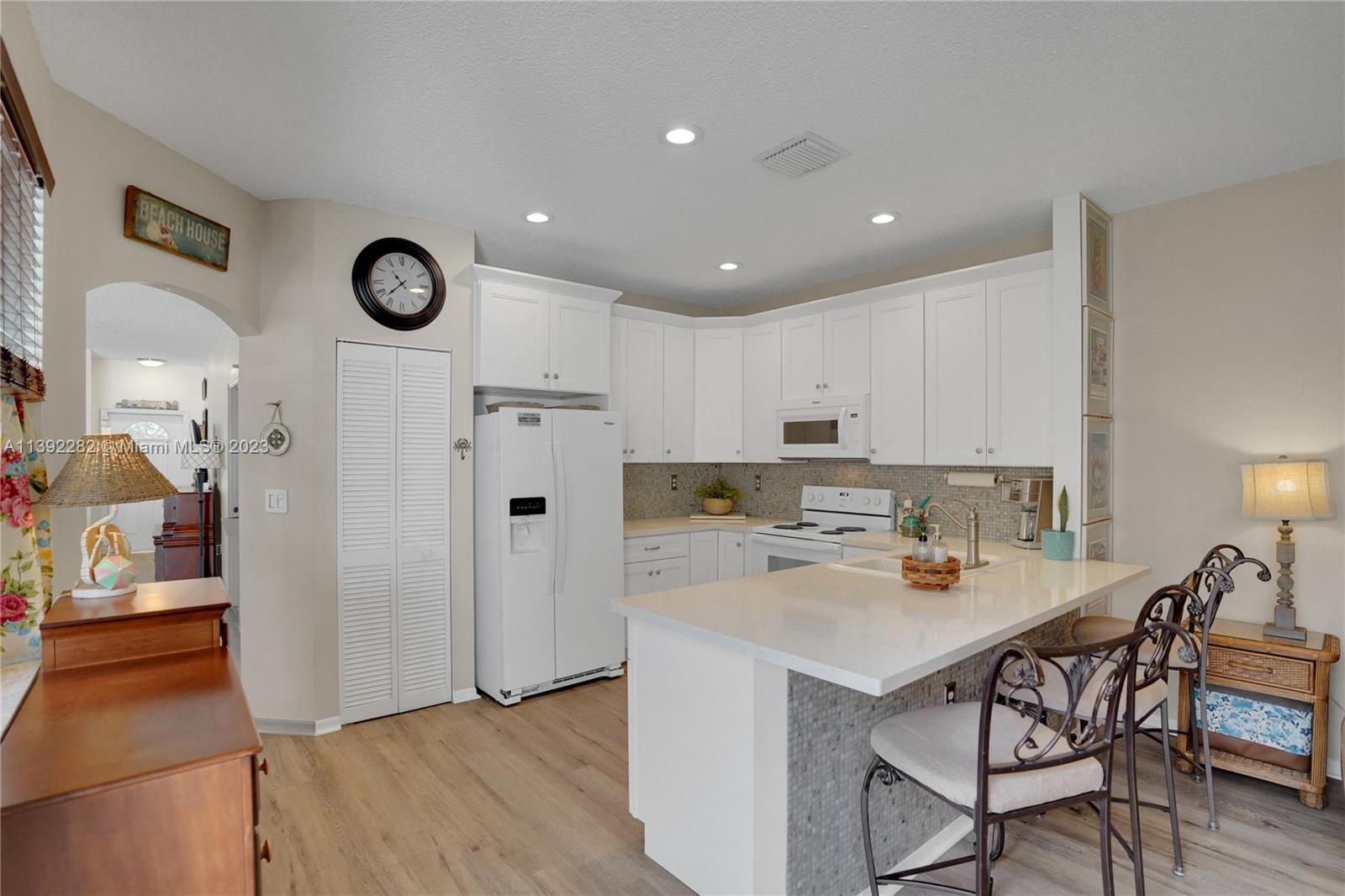 3850 Tree Top Road Cooper City, FL 33026 - Photo 10 of 34 a kitchen with a refrigerator a stove top oven a sink and cabinets