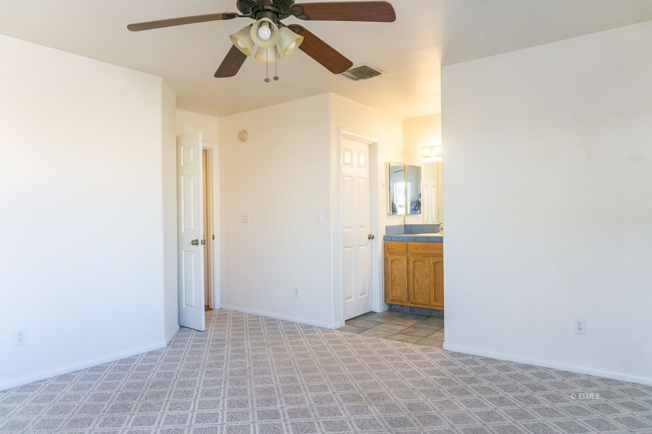 915 Sims Street Ridgecrest, CA 93555 - Photo 24 of 37 a view of empty room with wooden floor and fan