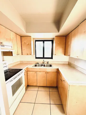 a kitchen with a sink stove and cabinets