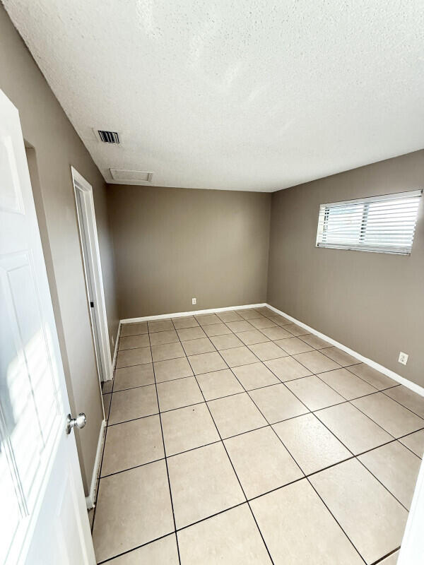 814 North G Street, Unit 1 Lake Worth Beach, FL 33460 - Photo 3 of 5 a view of a livingroom with an empty space and a window