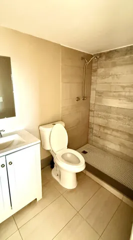 a bathroom with a toilet and a shower