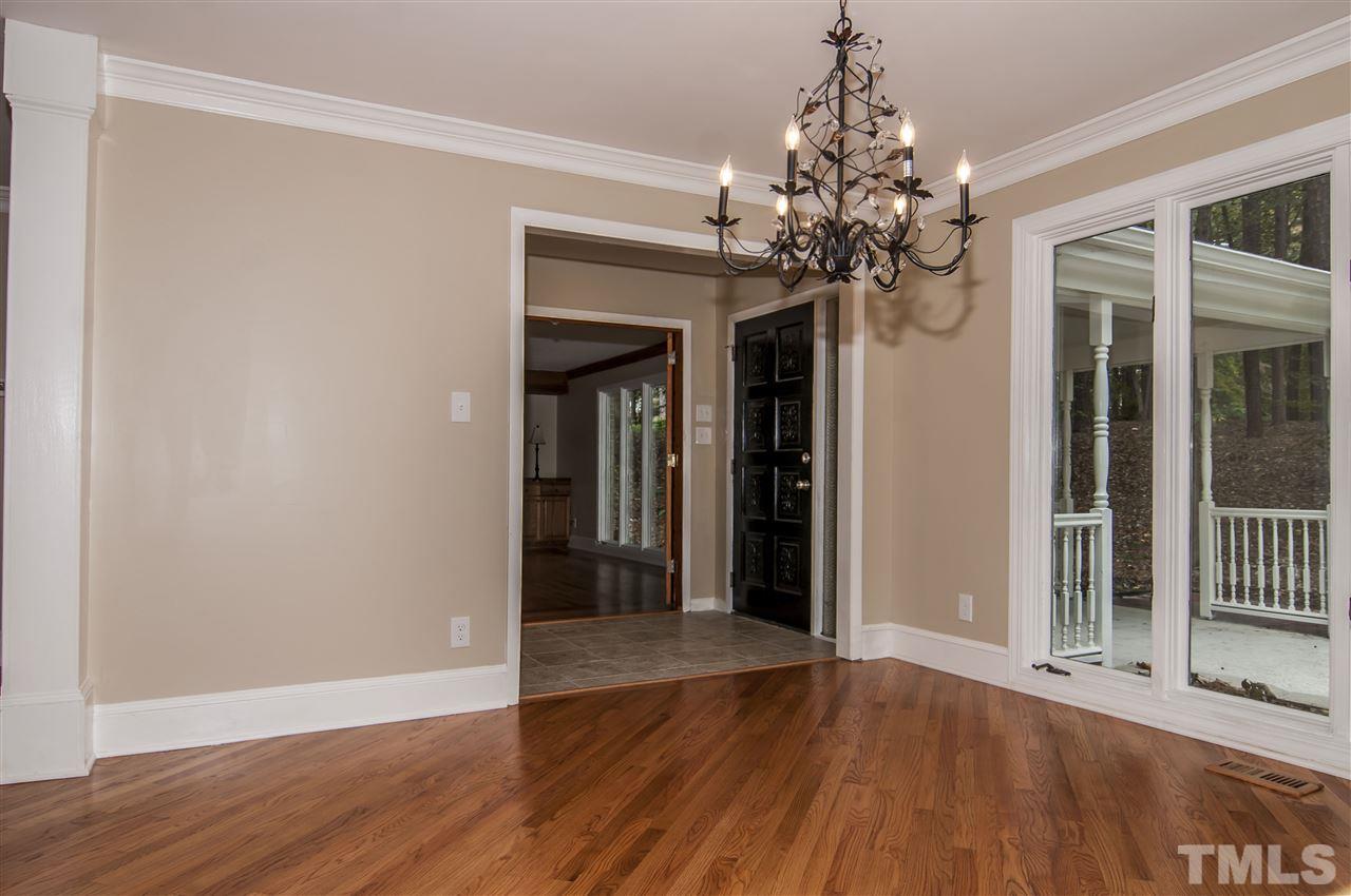8828 Stage Ford Road Raleigh, NC 27615 - Photo 7 of 25 a view of a chandelier in a room with wooden floor and a chandelier