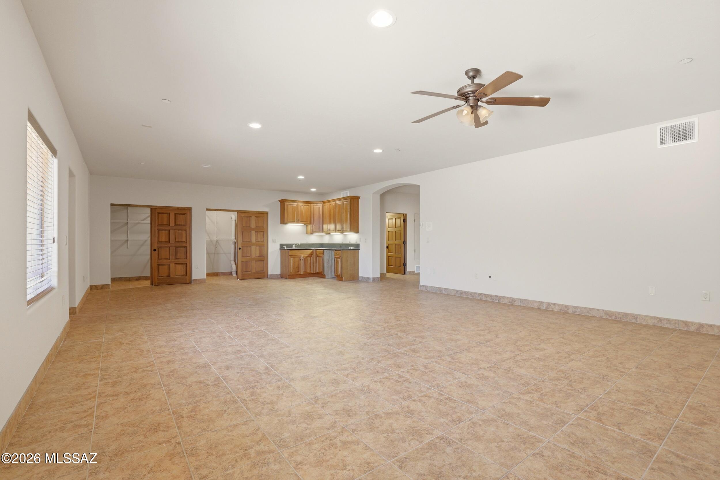 6331 West Trails End Road Tucson, AZ 85745 - Photo 30 of 41 a view of empty room with wooden floor and window