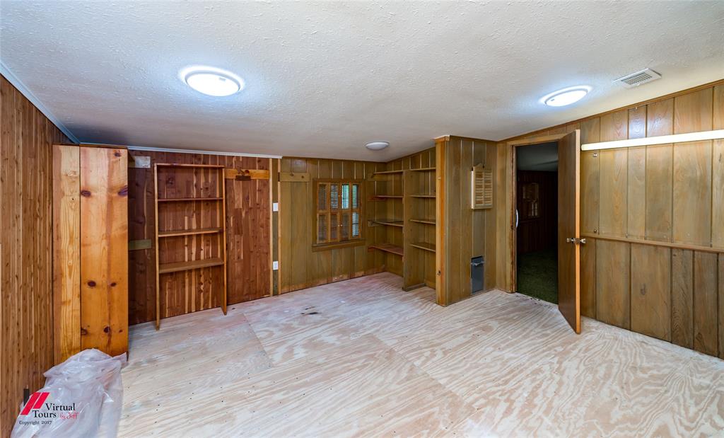 205 7th Street Northeast Springhill, LA 71075 - Photo 30 of 40 Wood paneling throughout, built-in shelving units, recessed ceiling lighting, and a window with wood framing