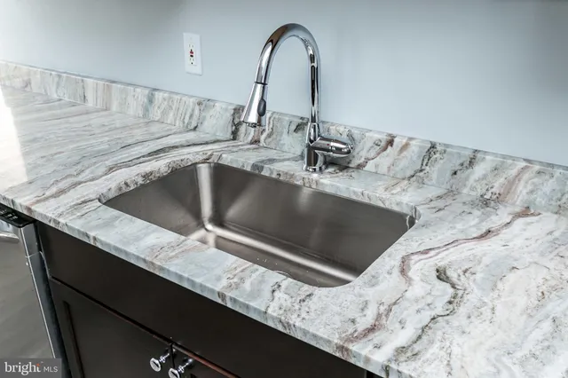 a kitchen with a stove a sink and a refrigerator