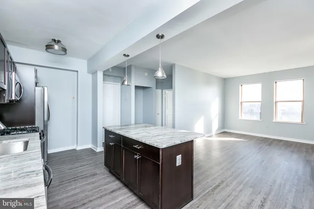 an empty room with windows cabinet and fire place