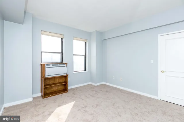 a view of an empty room with glass door