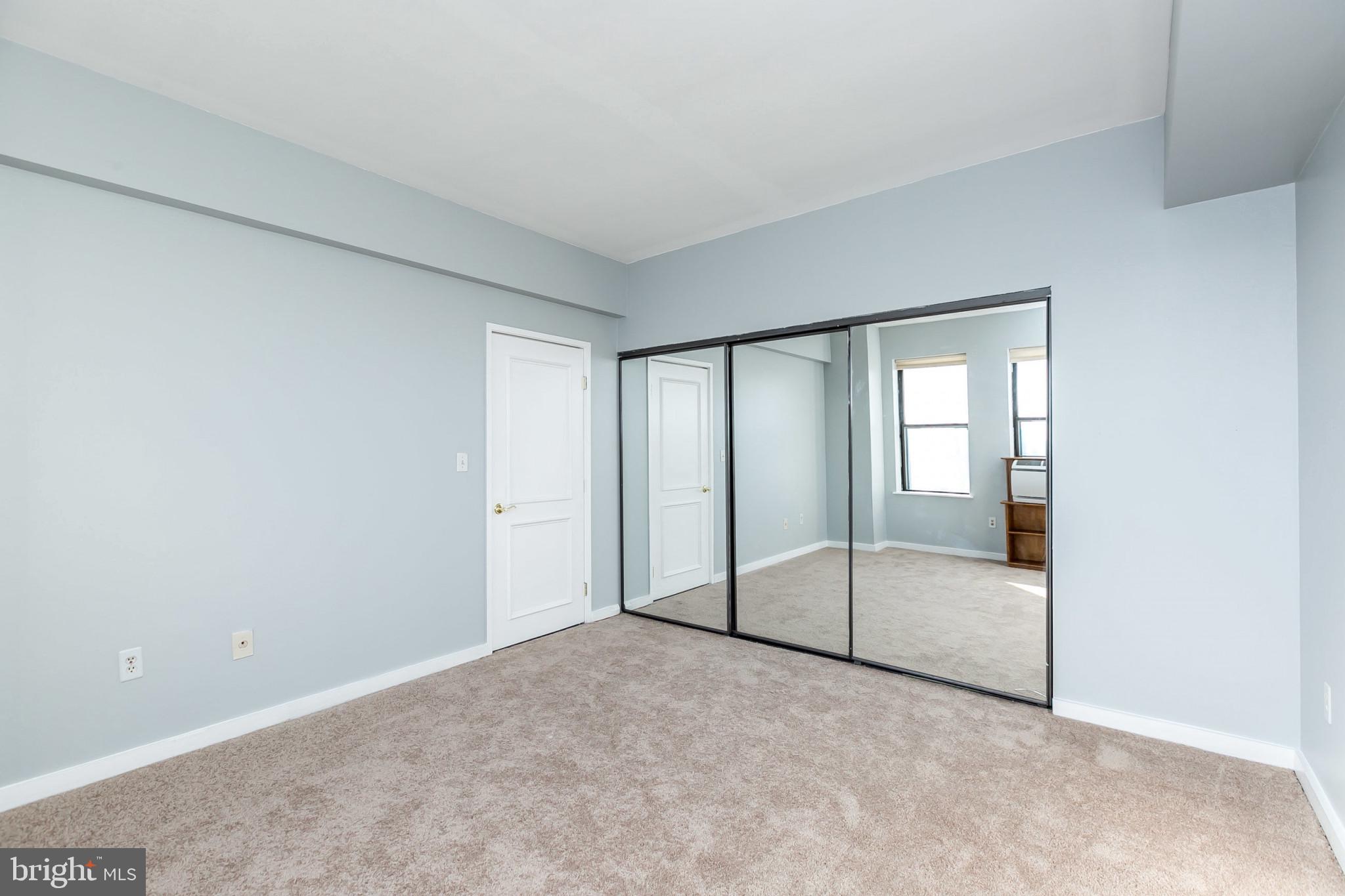 1001 St Paul Street, Unit 6G Baltimore, MD 21202 - Photo 18 of 32 a view of an empty room with glass door