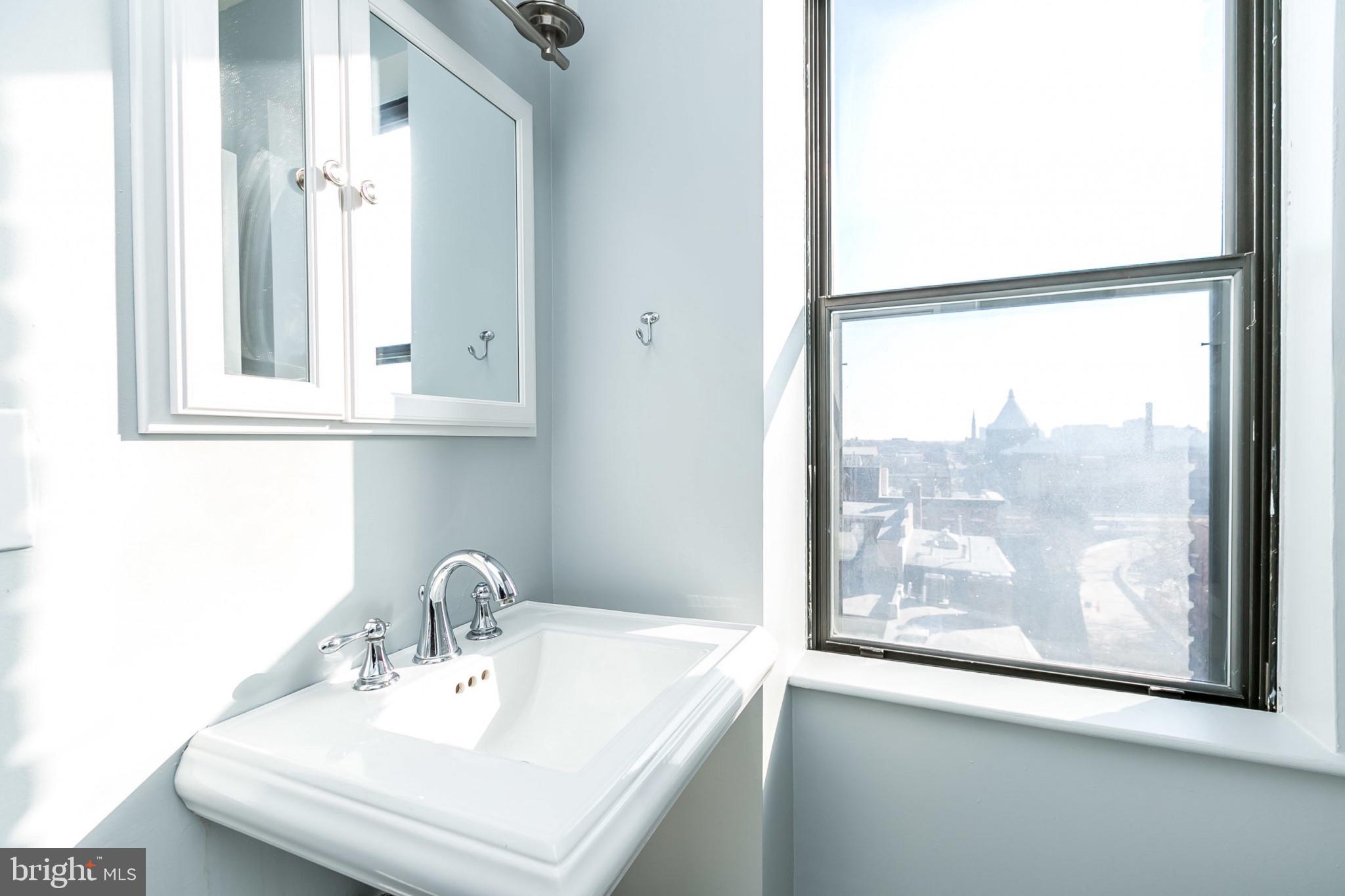 1001 St Paul Street, Unit 6G Baltimore, MD 21202 - Photo 21 of 32 a bathroom with a sink and a window