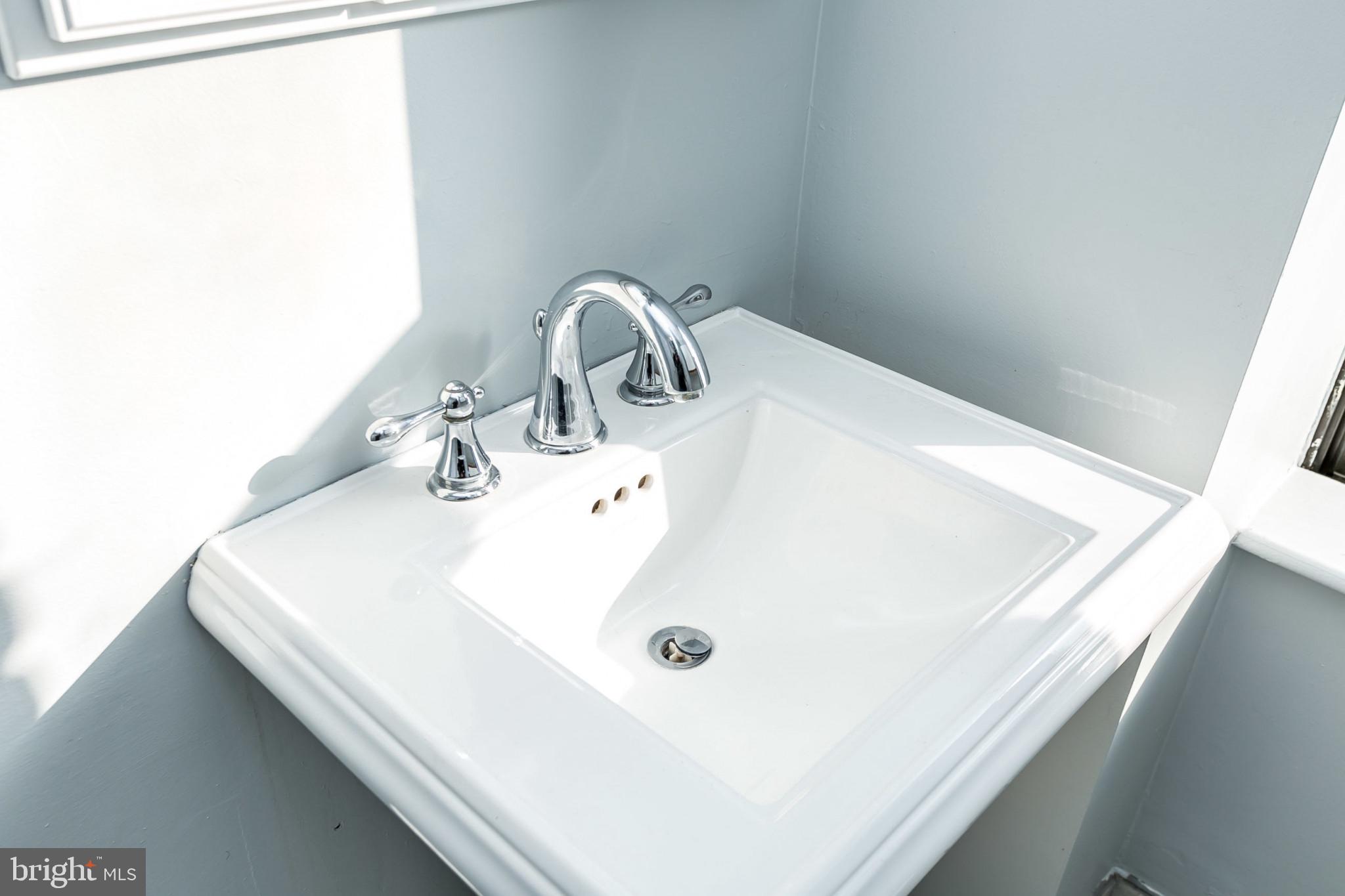 1001 St Paul Street, Unit 6G Baltimore, MD 21202 - Photo 22 of 32 a bathroom with a sink and a mirror