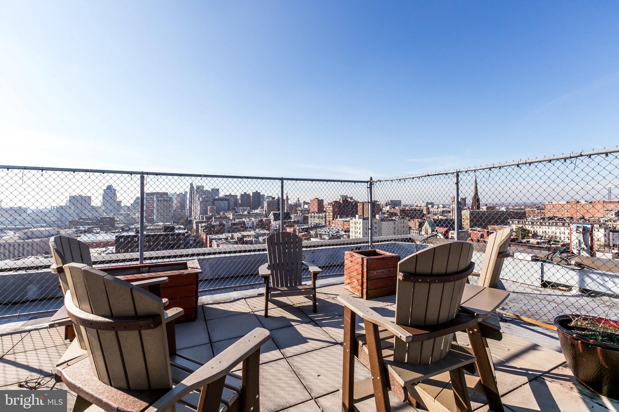 1001 St Paul Street, Unit 6G Baltimore, MD 21202 - Photo 25 of 32 a view of a chairs and table on the terrace