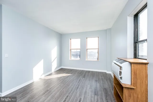 a kitchen with stainless steel appliances wooden floors and wooden cabinets
