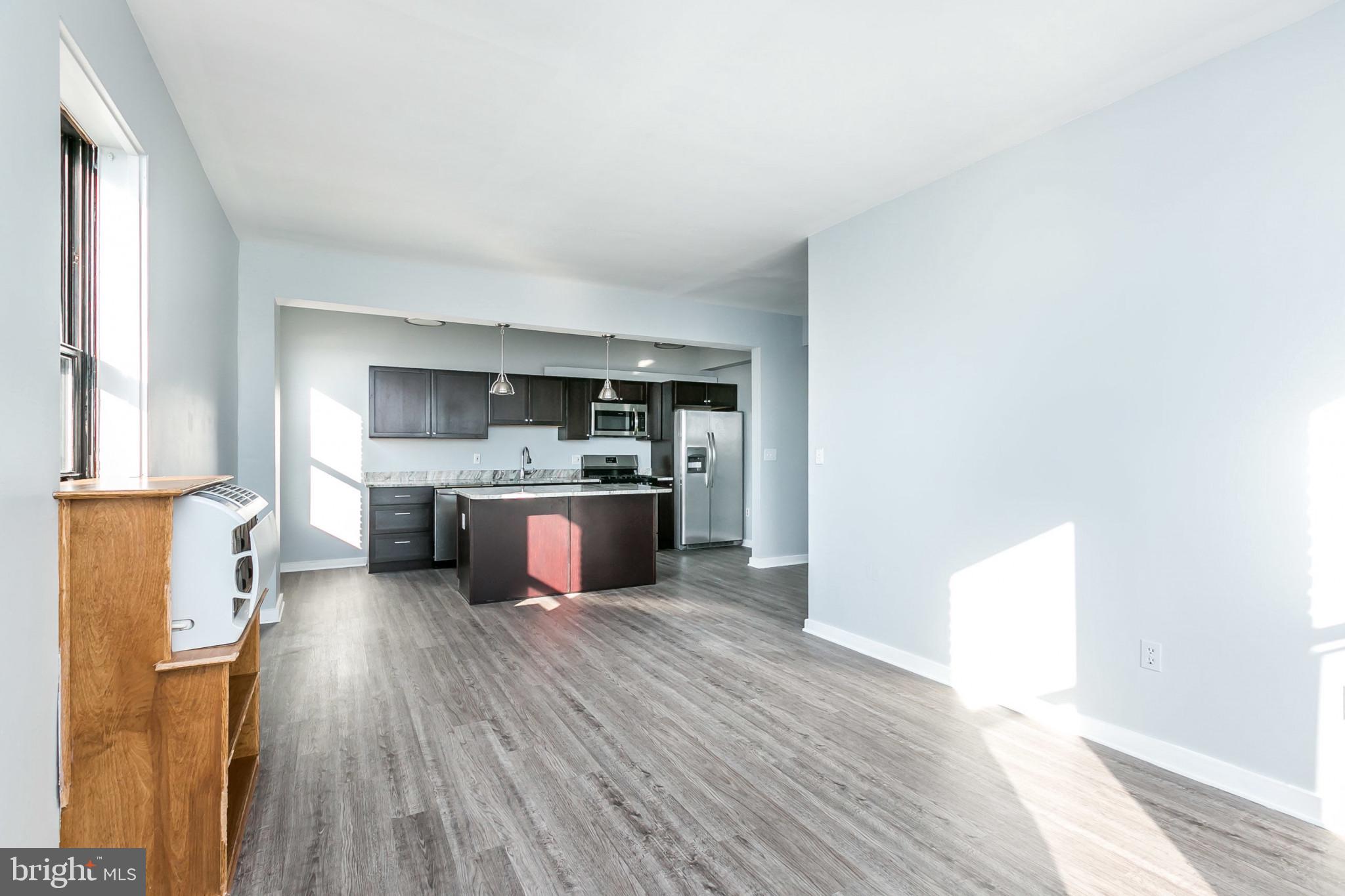 1001 St Paul Street, Unit 6G Baltimore, MD 21202 - Photo 6 of 32 a kitchen with stainless steel appliances a sink and a refrigerator